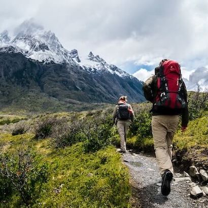 Hikers trekking through the stunning mountains of Albania, with scenic views of Valbona Valley and Theth.