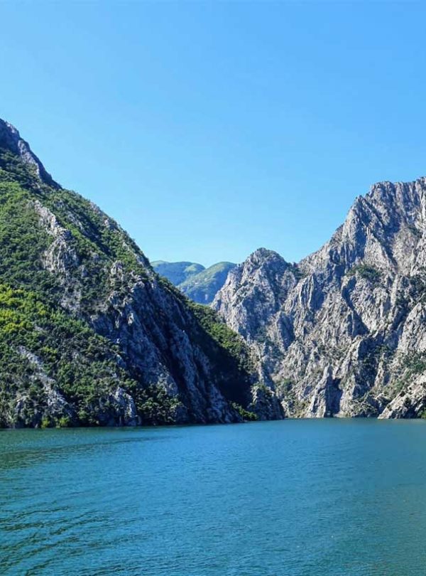 Breathtaking mountain views of Fierze, Albania, with clear blue waters of the reservoir.