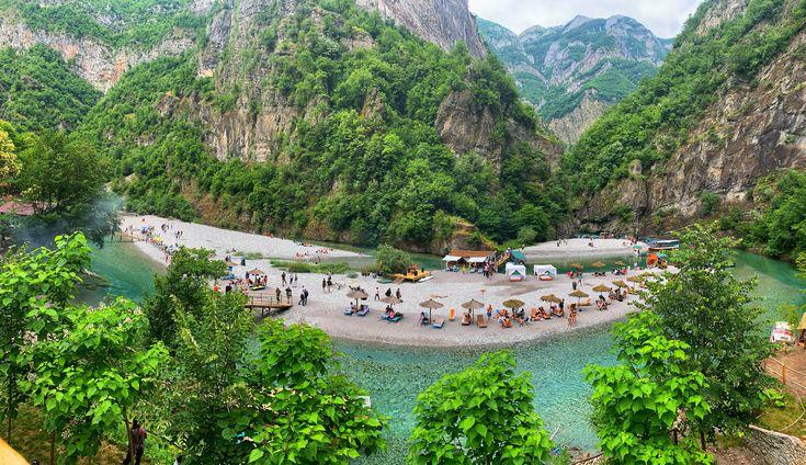 Shala River crystal-clear water between tall green mountains